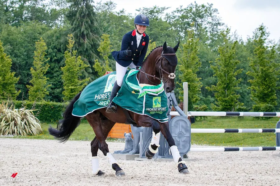 Laura Collett riding cross-country at an eventing competition.