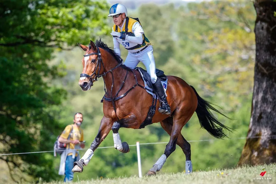 Andrew Hoy riding cross-country at an eventing competition.