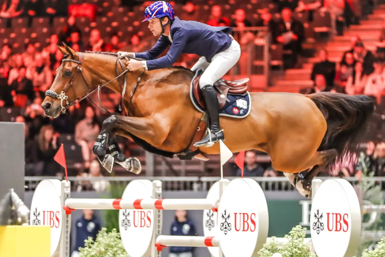 Karl Cook competing at the CHI de Genève, his horse fitted with the Alogo Move Pro sensor.